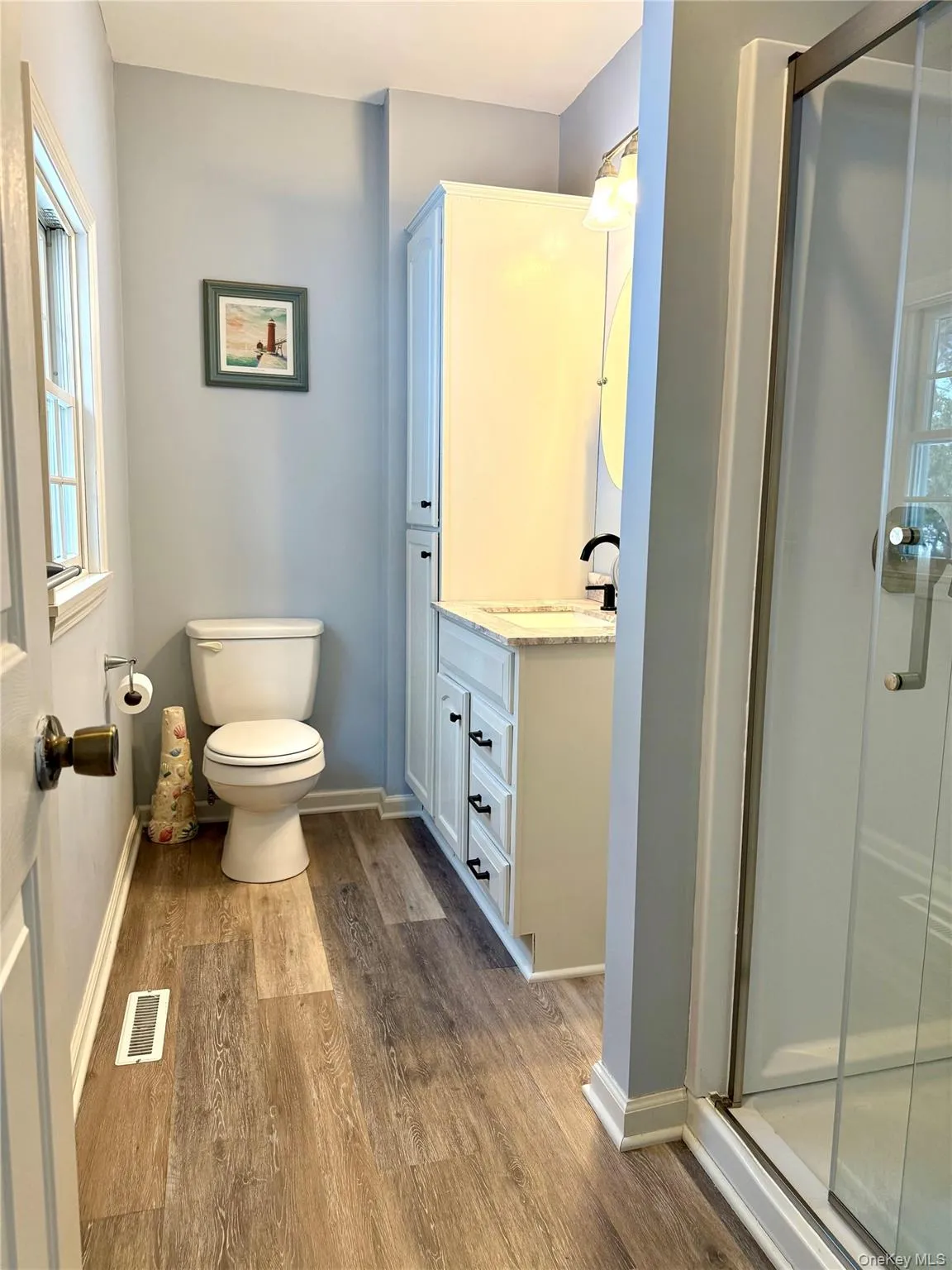 Full bath with plenty of natural light, a shower stall, and vanity Full bath with plenty of natural light, a shower stall, and vanity