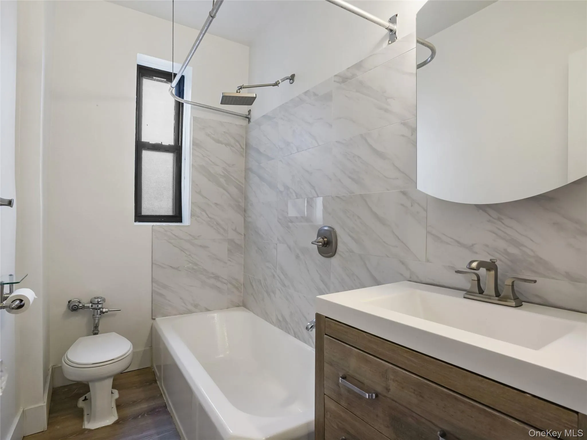 Update hall bath with wood vanity and shower/tub Update hall bath with wood vanity and shower/tub