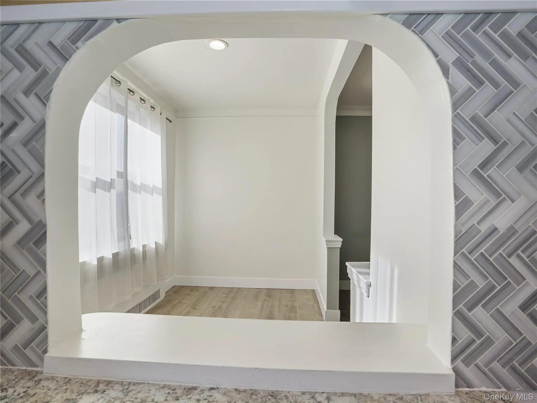 Arched pass through from the kitchen to the dining area Arched pass through from the kitchen to the dining area