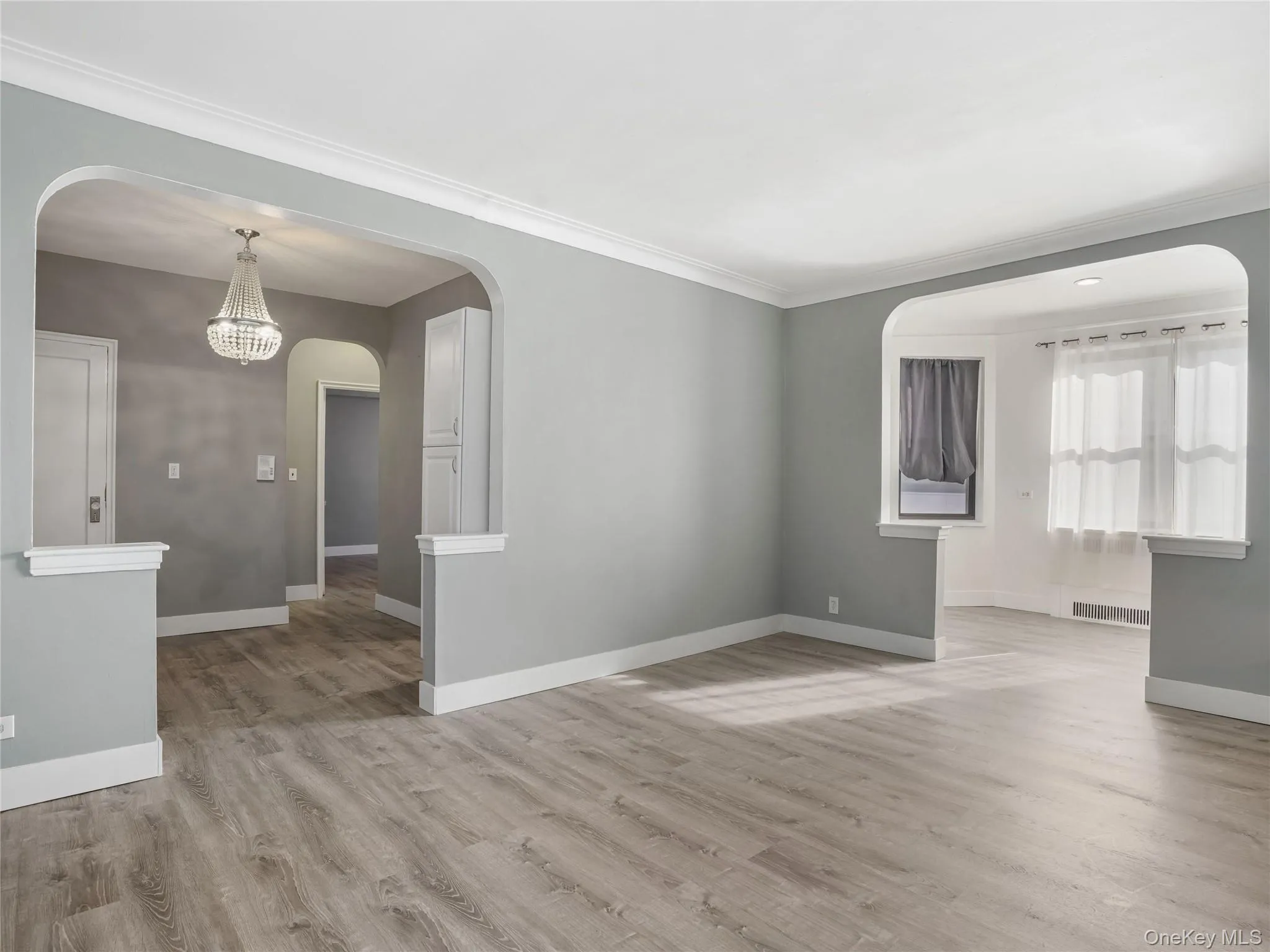 View of living room showing access to entry and dining area. View of living room showing access to entry and dining area.