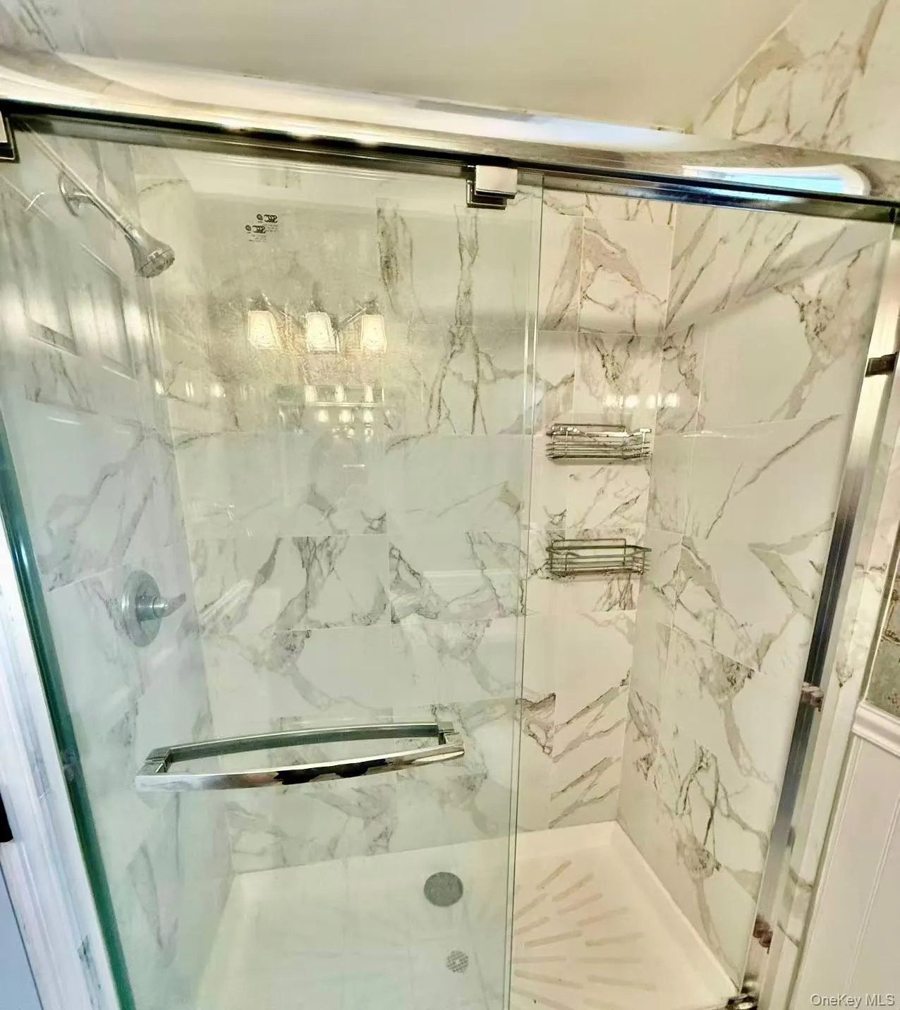 Full bathroom with a marble finish shower Full bathroom with a marble finish shower