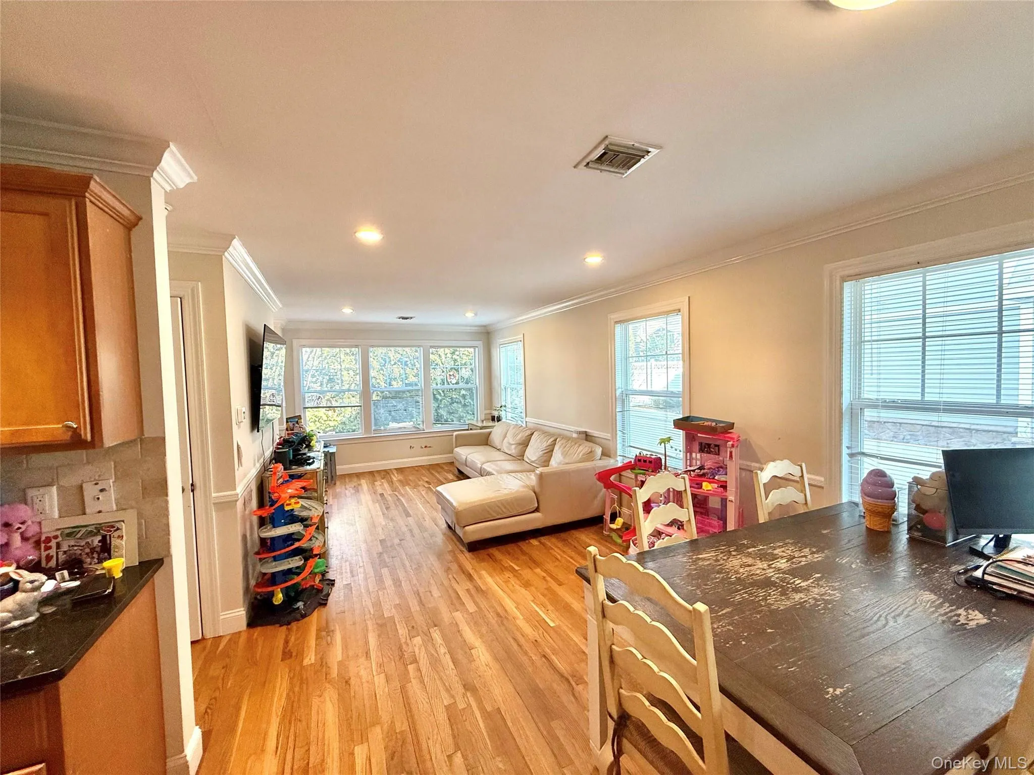 Dining room with light wood finished floors, crown molding, recessed lighting, and a desk Dining room with light wood finished floors, crown molding, recessed lighting, and a desk