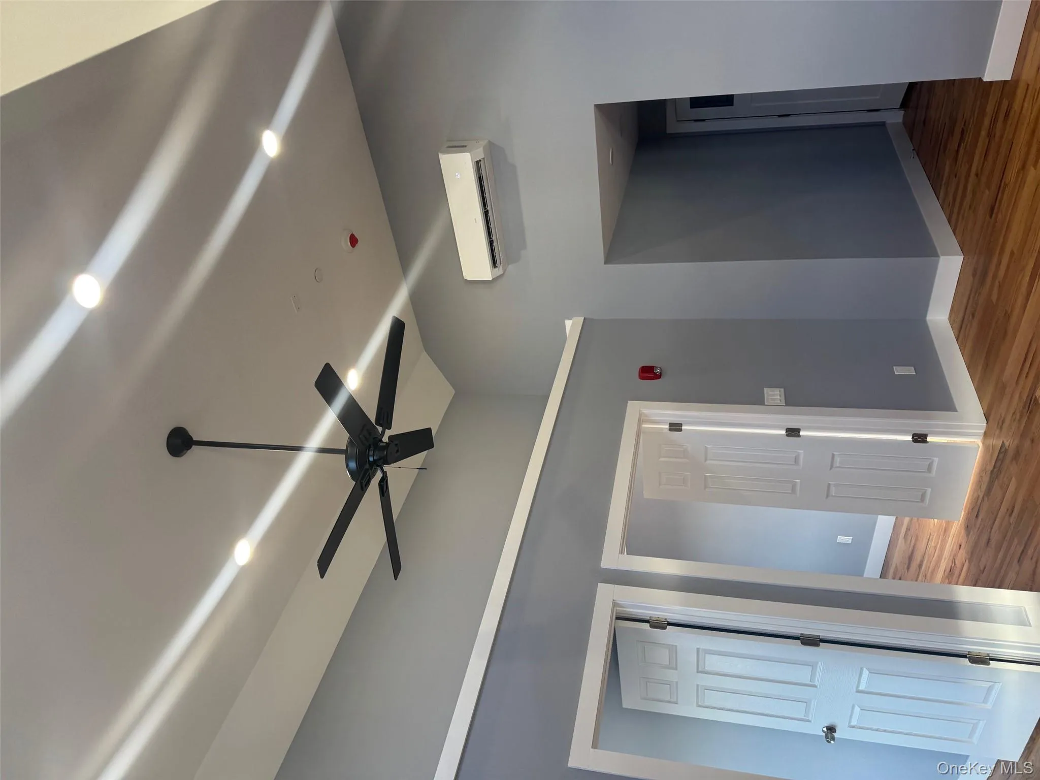 Spare room featuring wood finished floors and ceiling fan Spare room featuring wood finished floors and ceiling fan