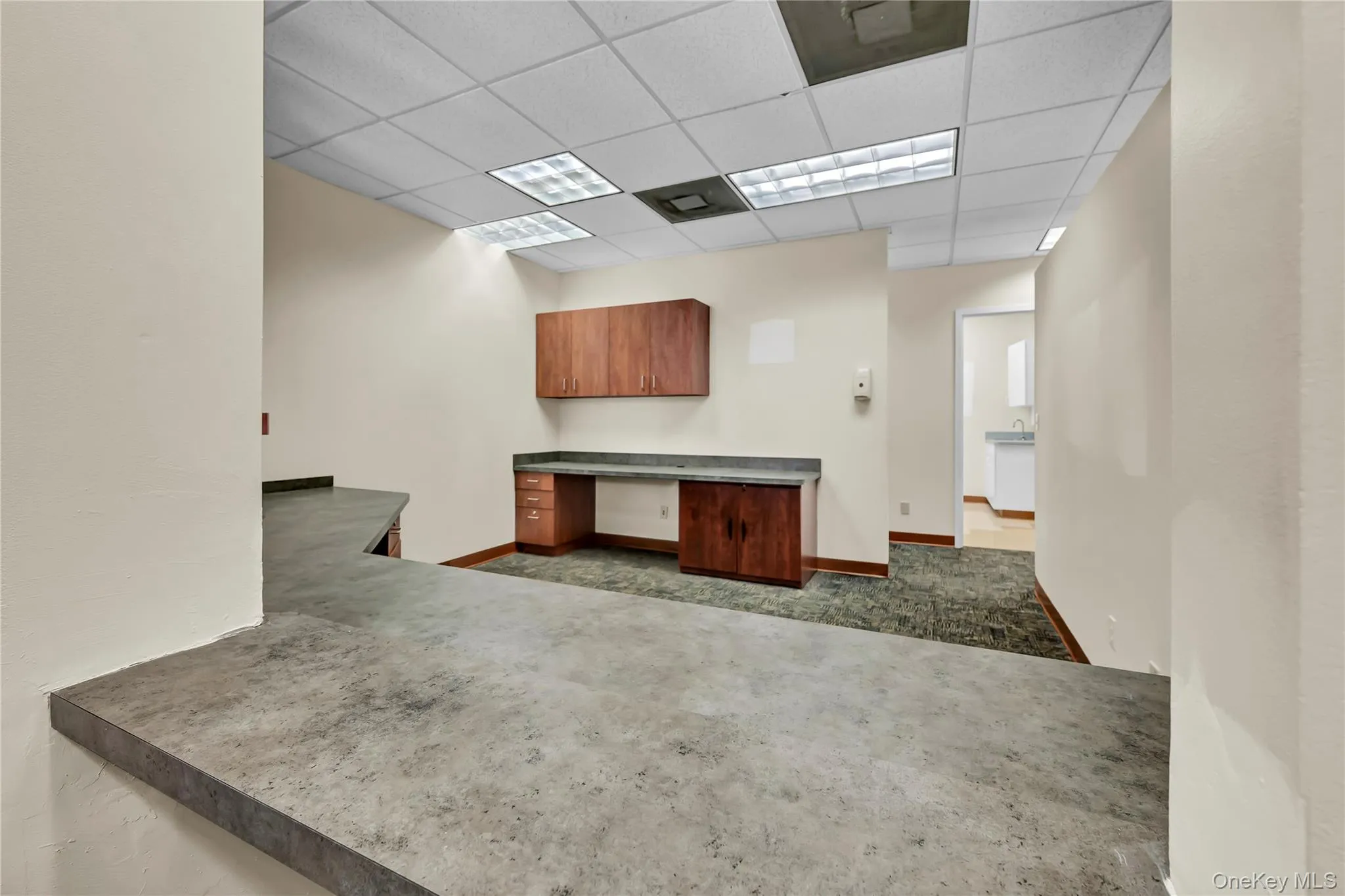 Unfurnished office featuring built in study area and a drop ceiling Unfurnished office featuring built in study area and a drop ceiling