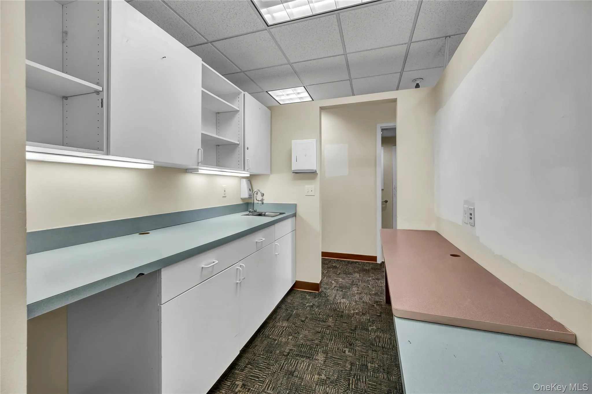 Kitchen with a paneled ceiling, open shelves, and white cabinets Kitchen with a paneled ceiling, open shelves, and white cabinets
