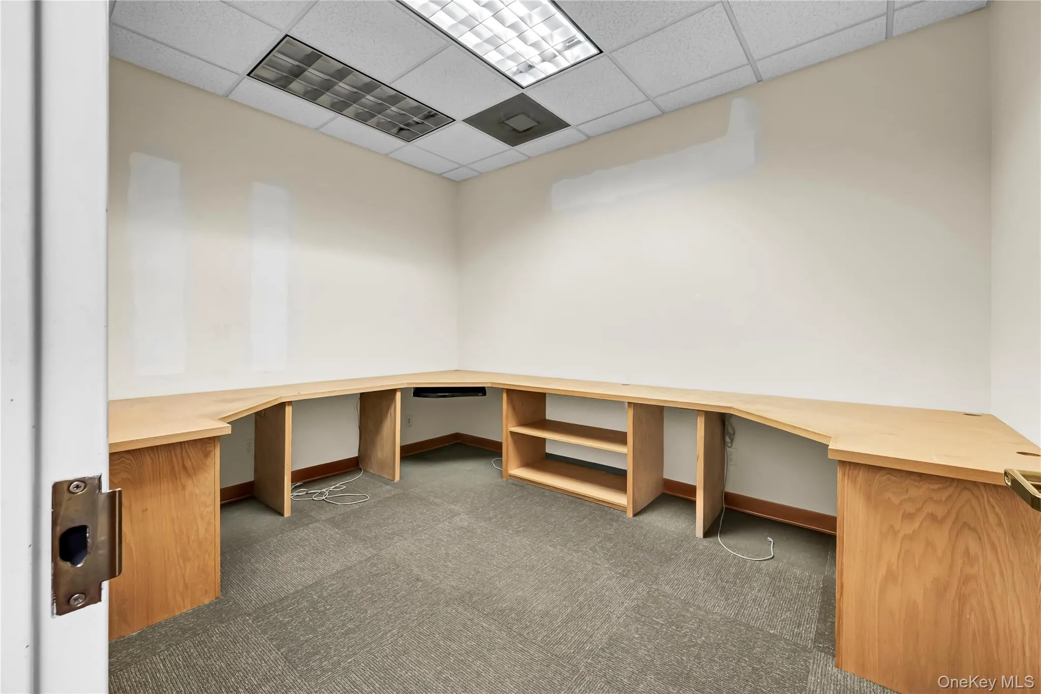 Unfurnished office featuring a drop ceiling and built in study area Unfurnished office featuring a drop ceiling and built in study area