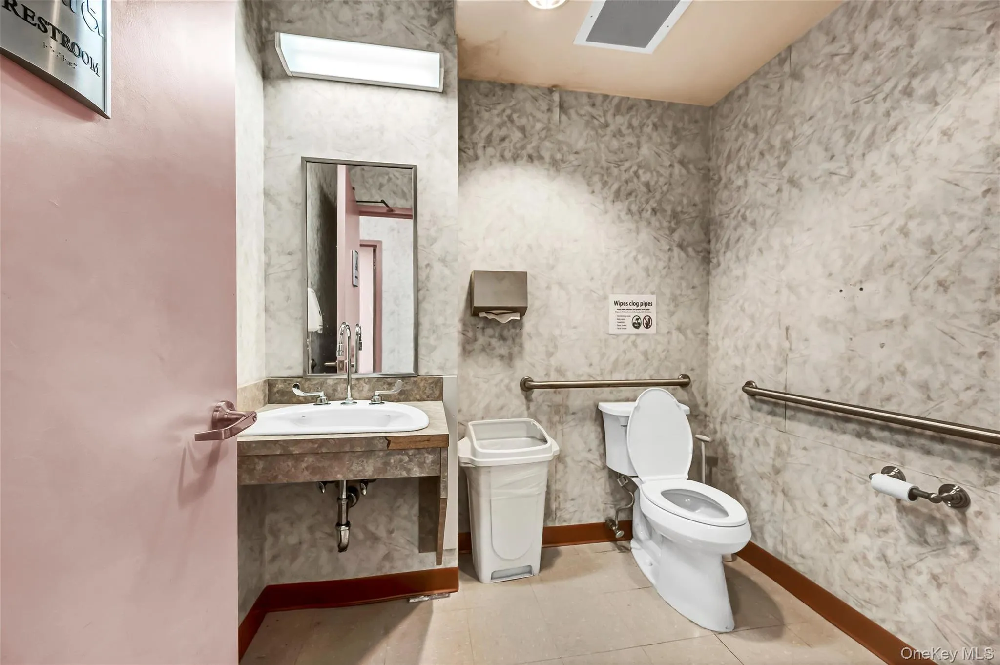 Bathroom featuring light tile patterned floors and vanity Bathroom featuring light tile patterned floors and vanity