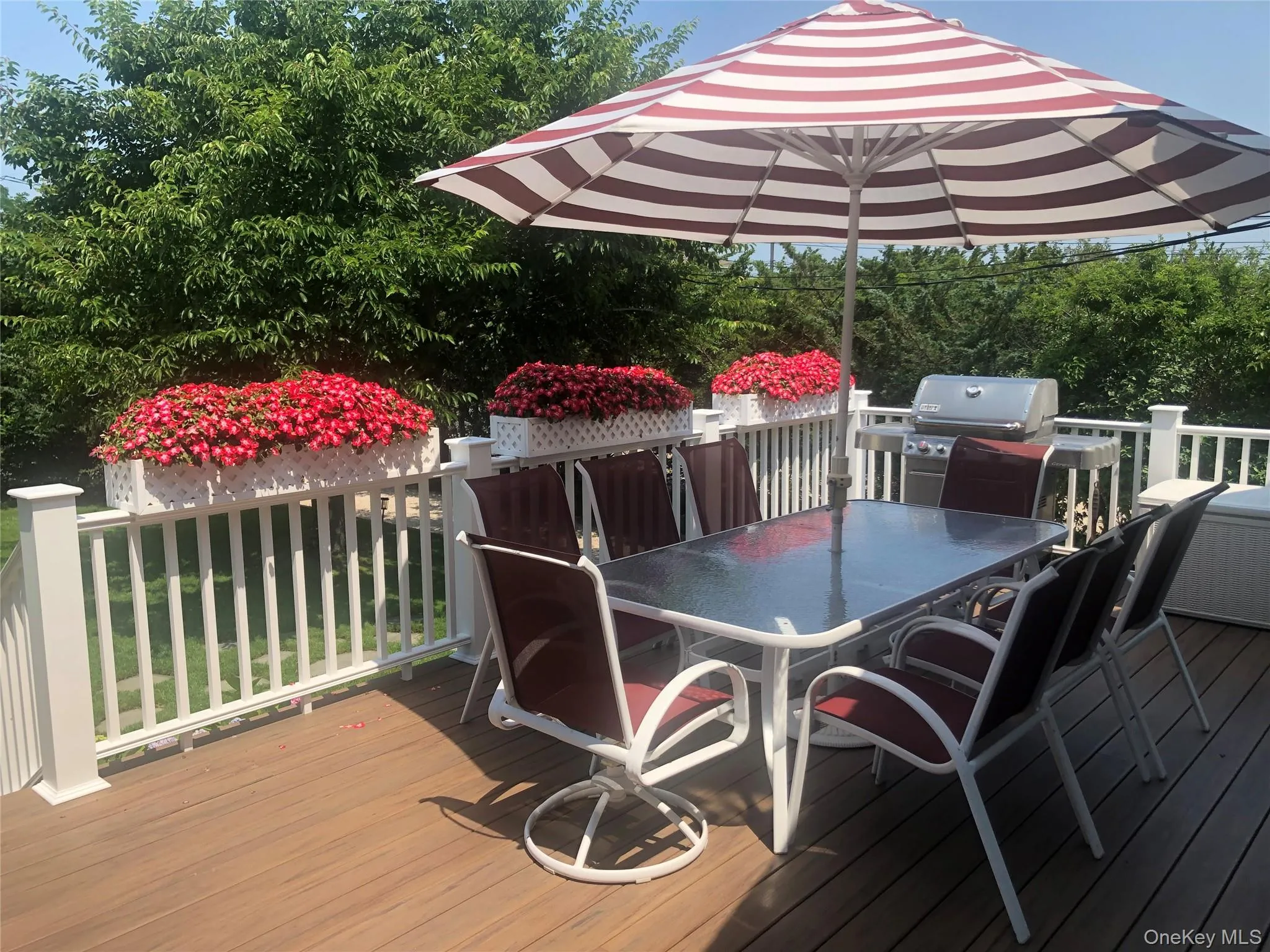 Wooden terrace with area for grilling and outdoor dining space Wooden terrace with area for grilling and outdoor dining space
