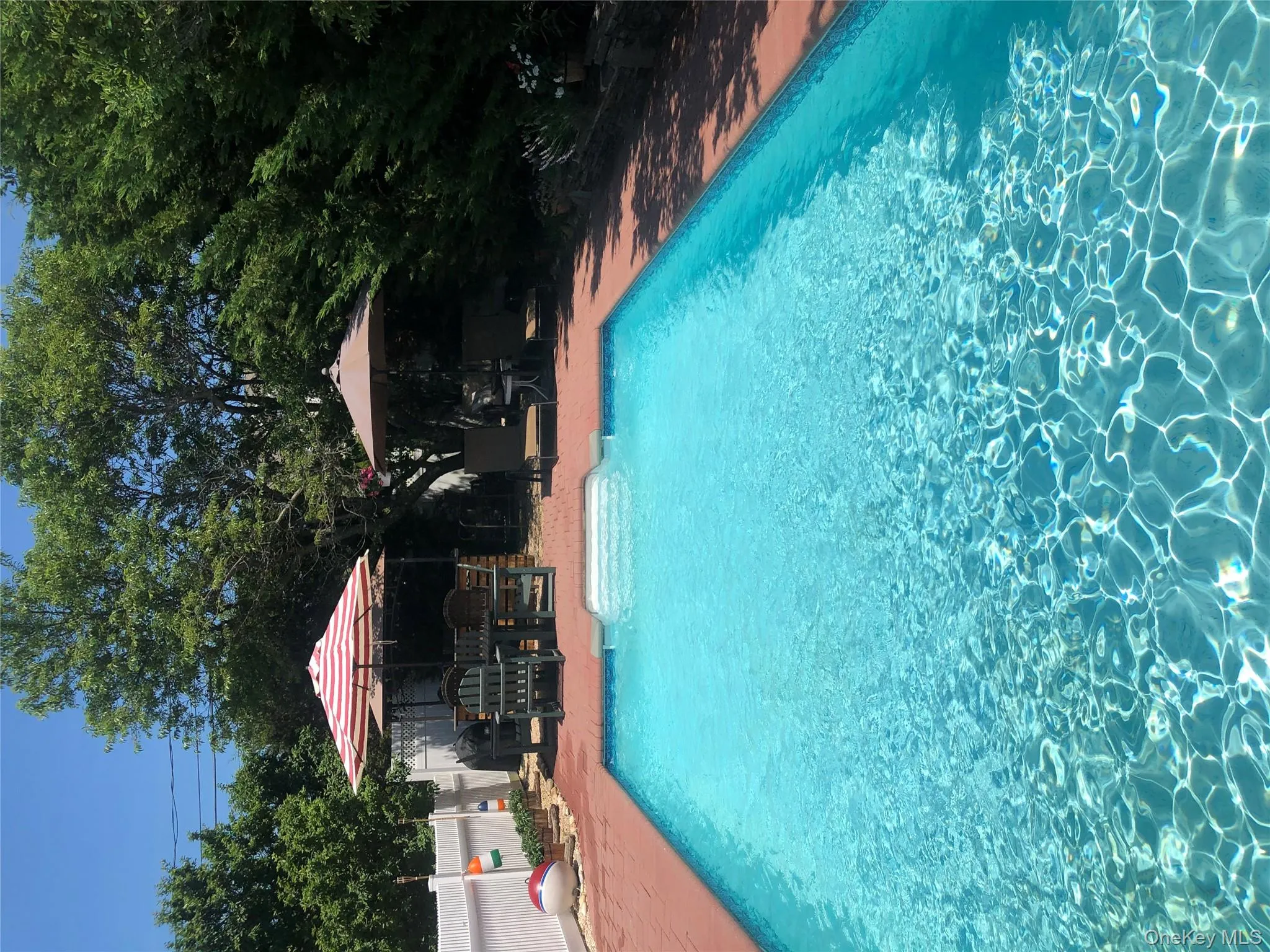 View of swimming pool with a wooden deck and a patio area View of swimming pool with a wooden deck and a patio area