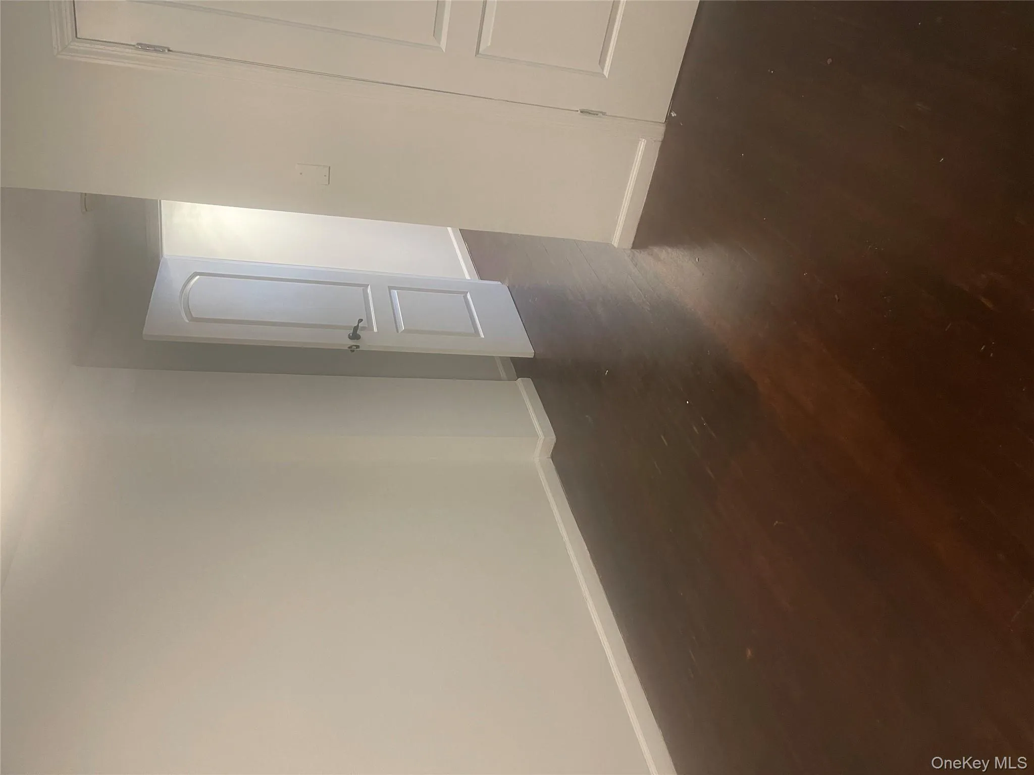 Empty room with baseboards and dark wood finished floors Empty room with baseboards and dark wood finished floors