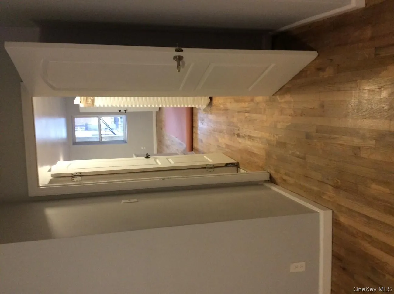 Hall featuring baseboards and wood finished floors Hall featuring baseboards and wood finished floors