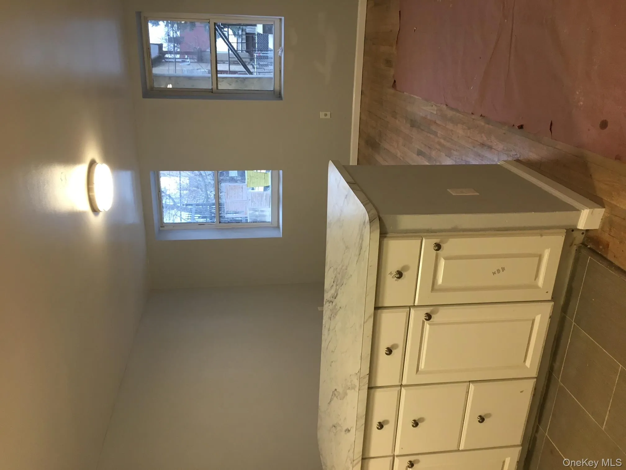 Kitchen featuring light countertops, white cabinetry, and dark wood finished floors Kitchen featuring light countertops, white cabinetry, and dark wood finished floors