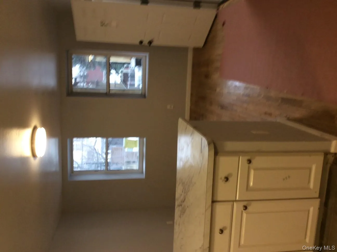 Kitchen with white cabinetry, light countertops, and dark wood finished floors Kitchen with white cabinetry, light countertops, and dark wood finished floors