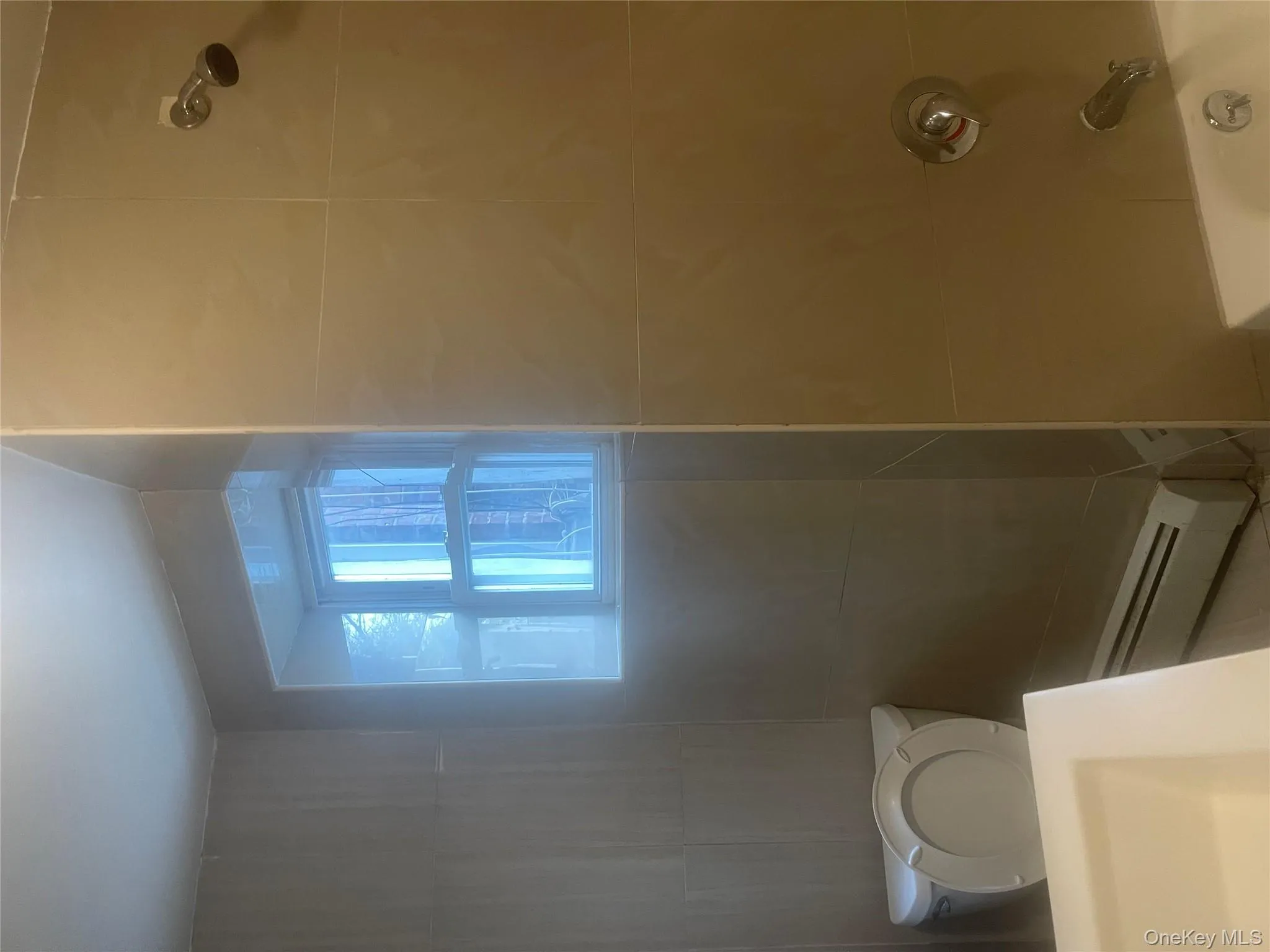 Full bathroom featuring baseboard heating, vanity, and shower / tub combination Full bathroom featuring baseboard heating, vanity, and shower / tub combination