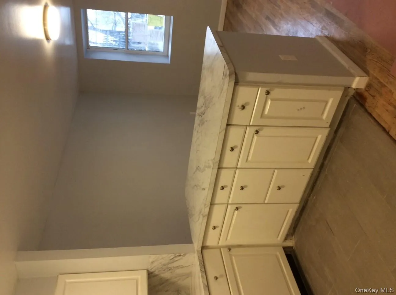 Kitchen featuring white cabinetry, dark wood finished floors, and tasteful backsplash Kitchen featuring white cabinetry, dark wood finished floors, and tasteful backsplash