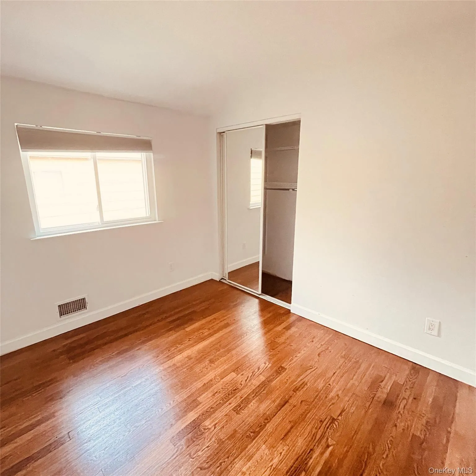 Unfurnished bedroom with light wood-style floors and a closet Unfurnished bedroom with light wood-style floors and a closet