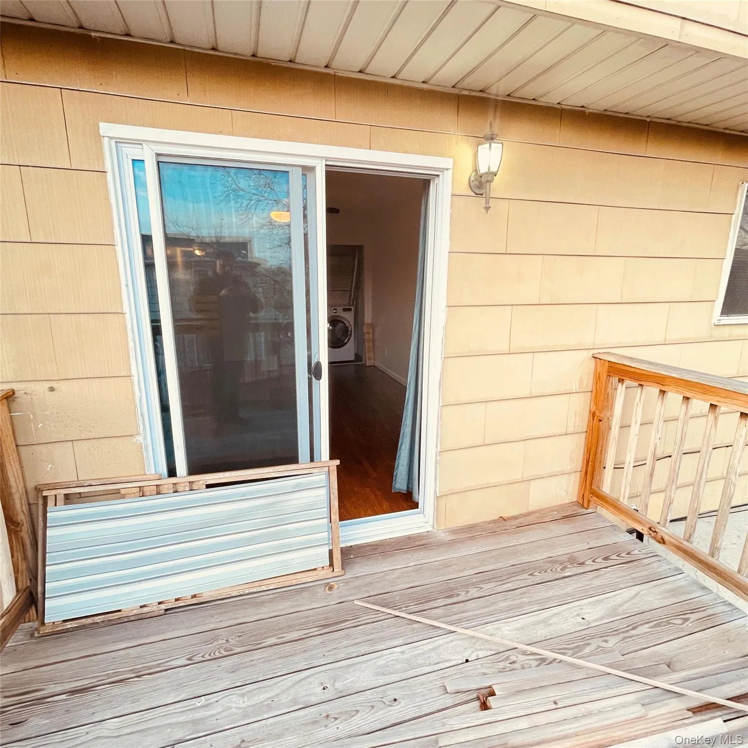 Property entrance with a deck and washer / clothes dryer Property entrance with a deck and washer / clothes dryer