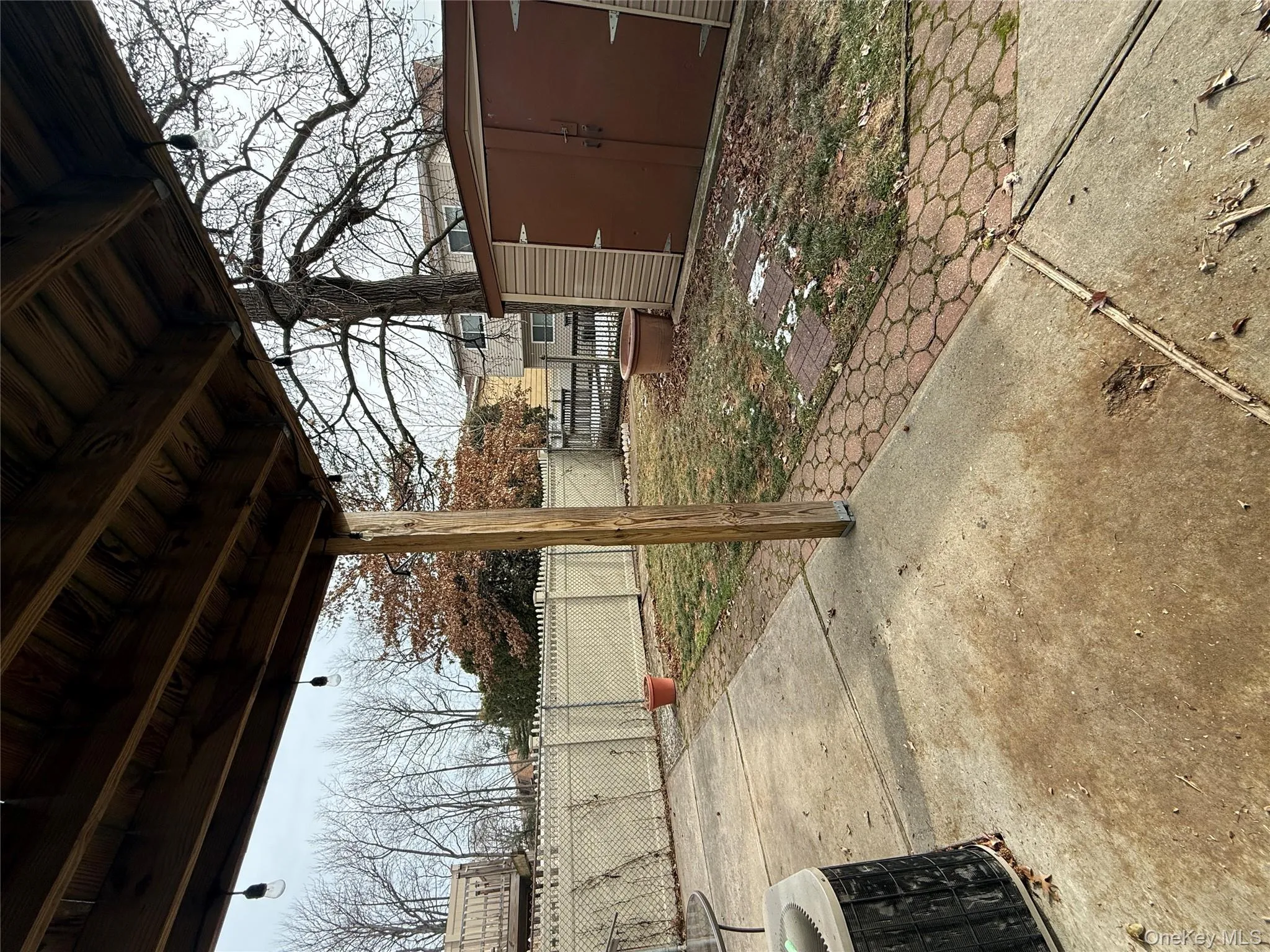 Fenced backyard with a patio and a storage shed Fenced backyard with a patio and a storage shed