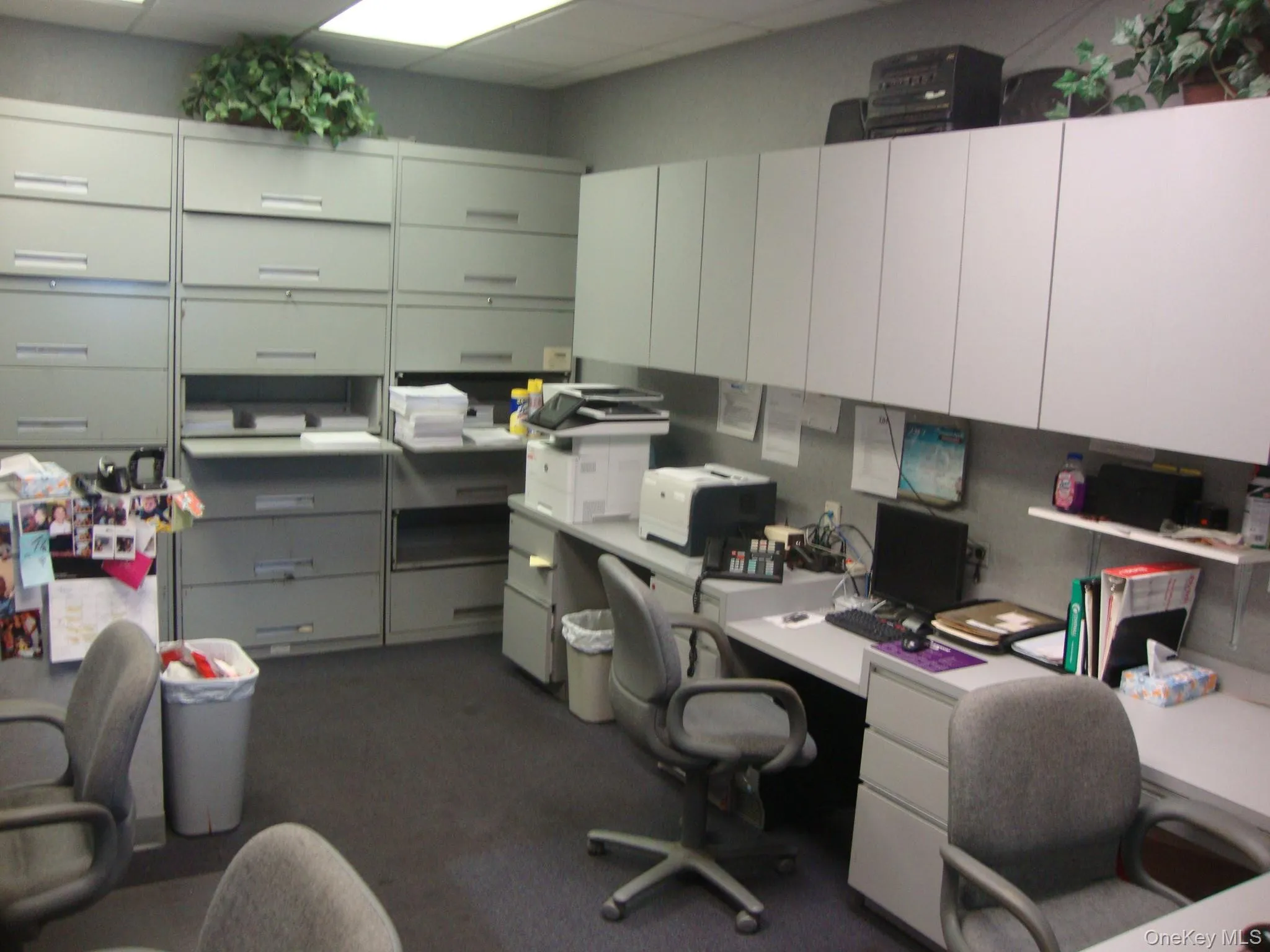 Office space featuring a drop ceiling and built in study area Office space featuring a drop ceiling and built in study area