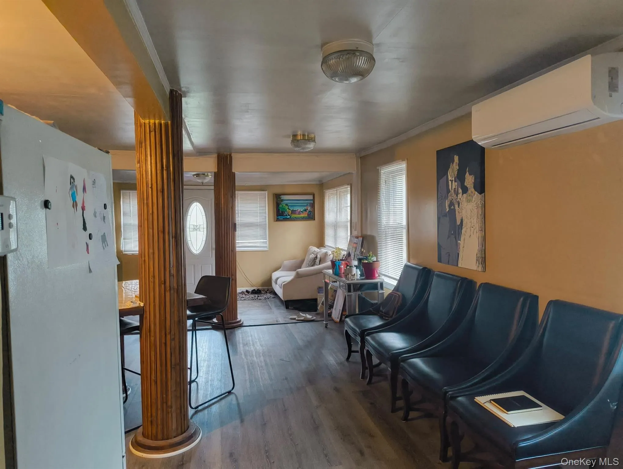 Entrance foyer with an AC wall unit and wood finished floors Entrance foyer with an AC wall unit and wood finished floors