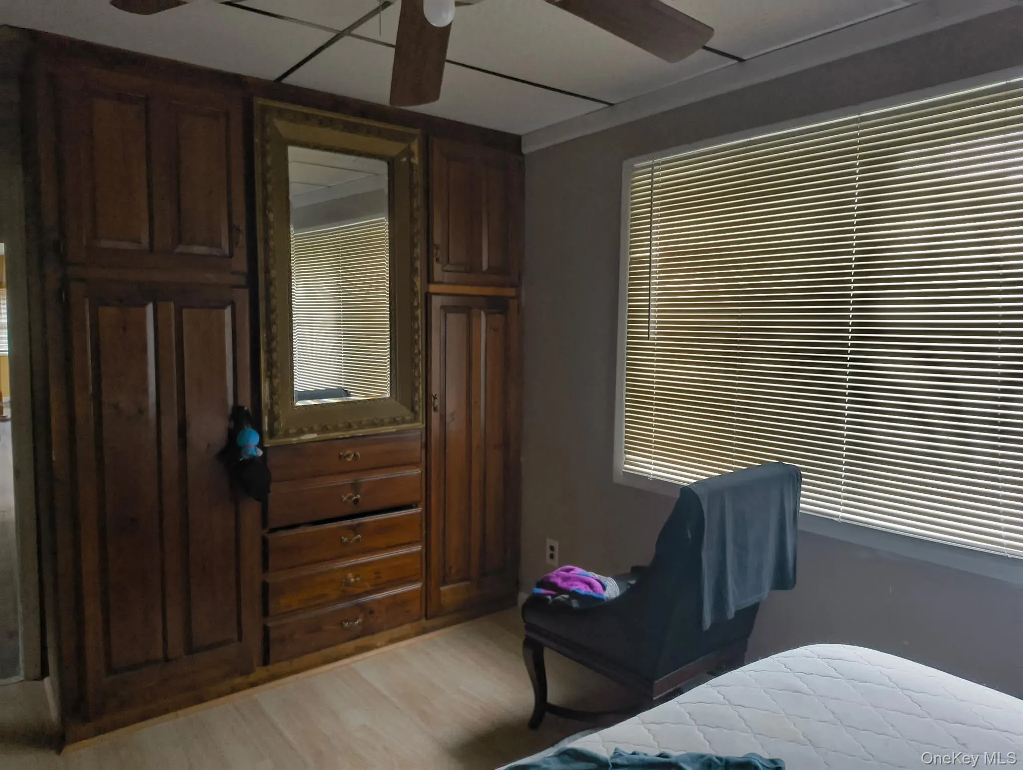 Bedroom featuring a ceiling fan and light wood-style floors Bedroom featuring a ceiling fan and light wood-style floors