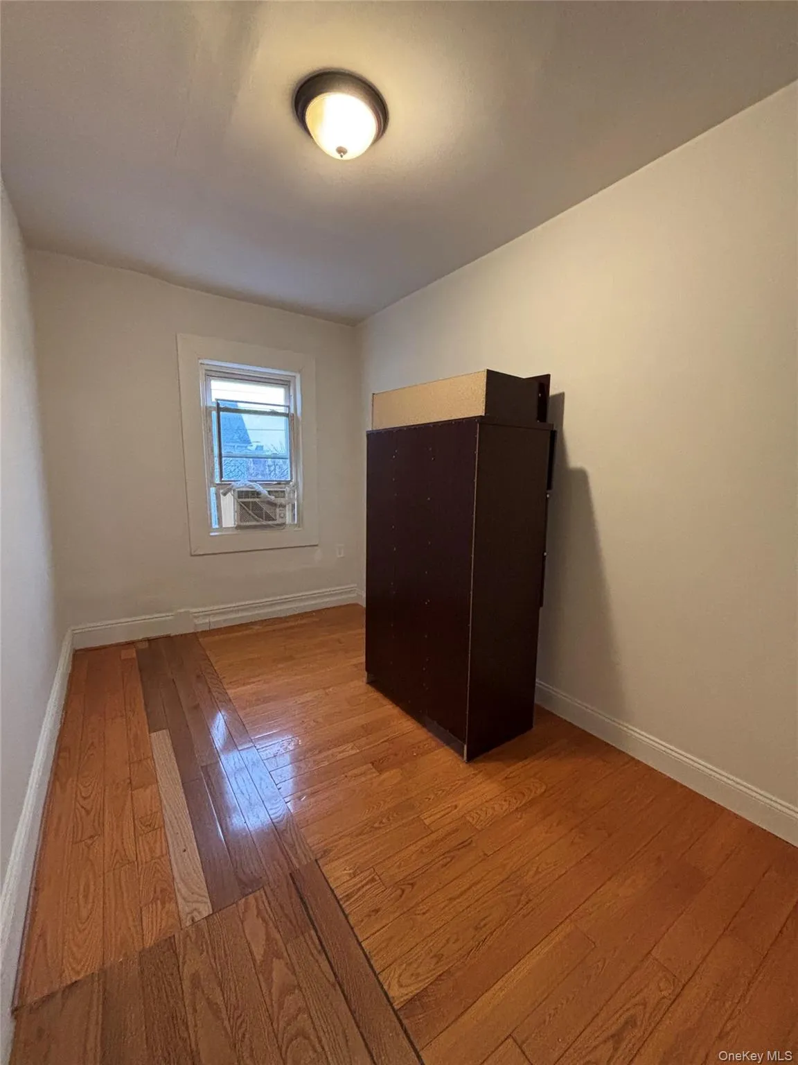 Unfurnished bedroom with light wood-type flooring and baseboards Unfurnished bedroom with light wood-type flooring and baseboards