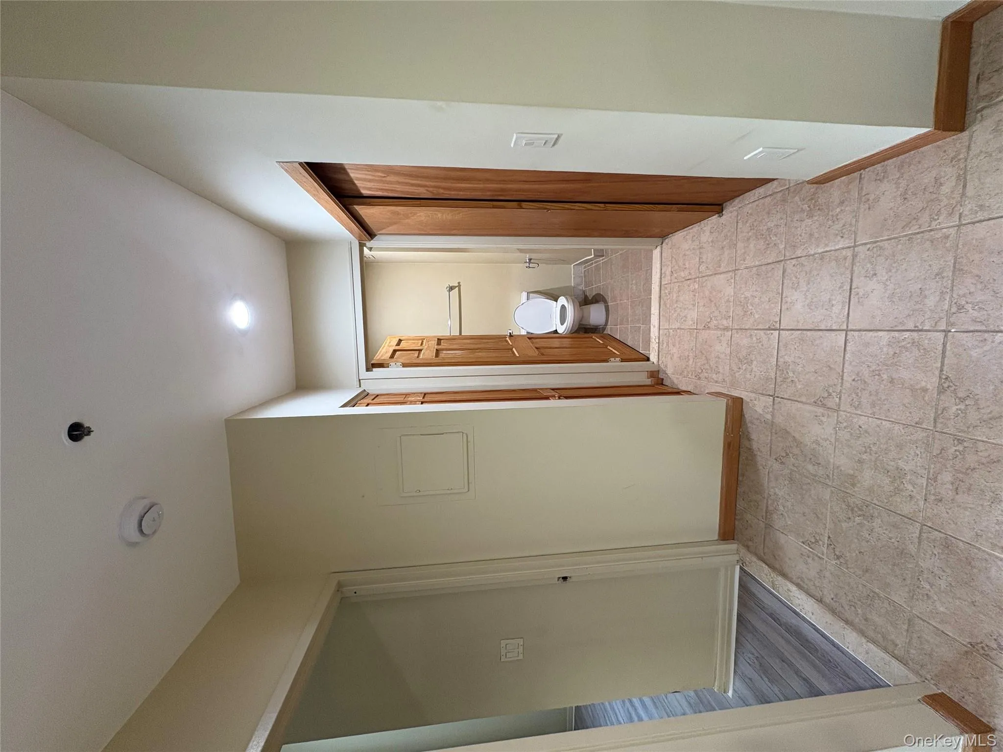 Hall featuring baseboards and light tile patterned floors Hall featuring baseboards and light tile patterned floors
