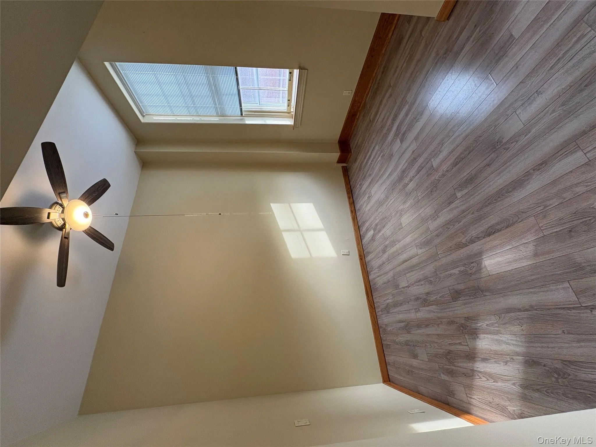 Spare room with light wood-style floors and a ceiling fan Spare room with light wood-style floors and a ceiling fan