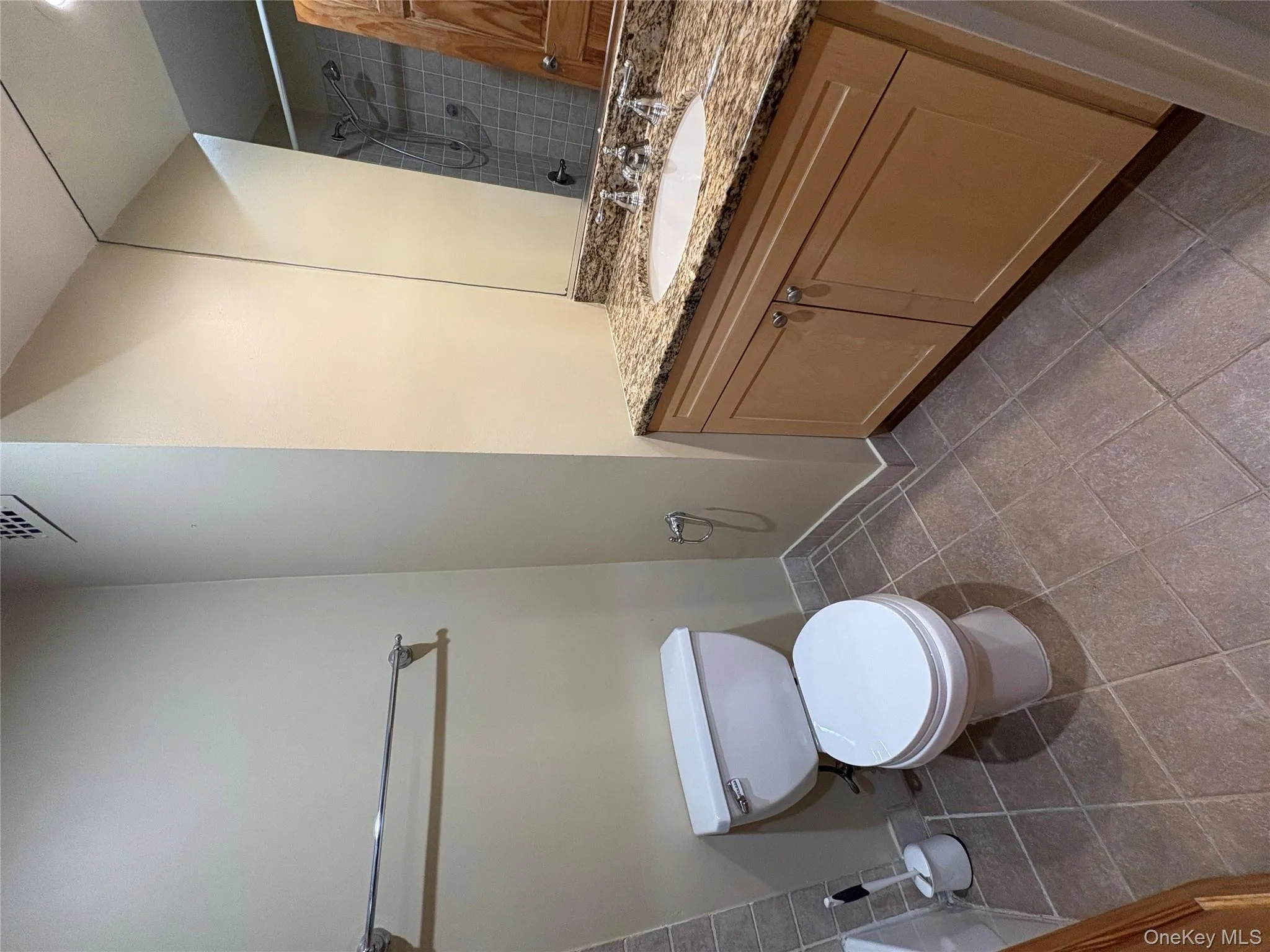 Bathroom featuring vanity, a shower with shower curtain, and light tile patterned floors Bathroom featuring vanity, a shower with shower curtain, and light tile patterned floors