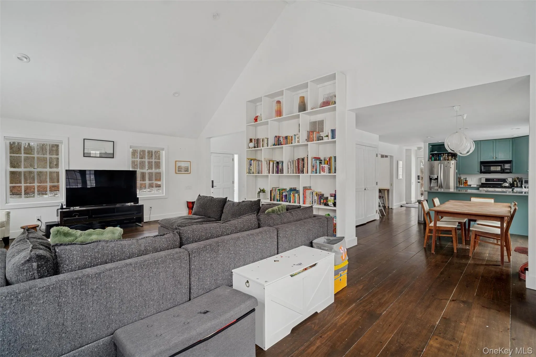 Living room featuring high vaulted ceiling and dark wood finished floors Living room featuring high vaulted ceiling and dark wood finished floors