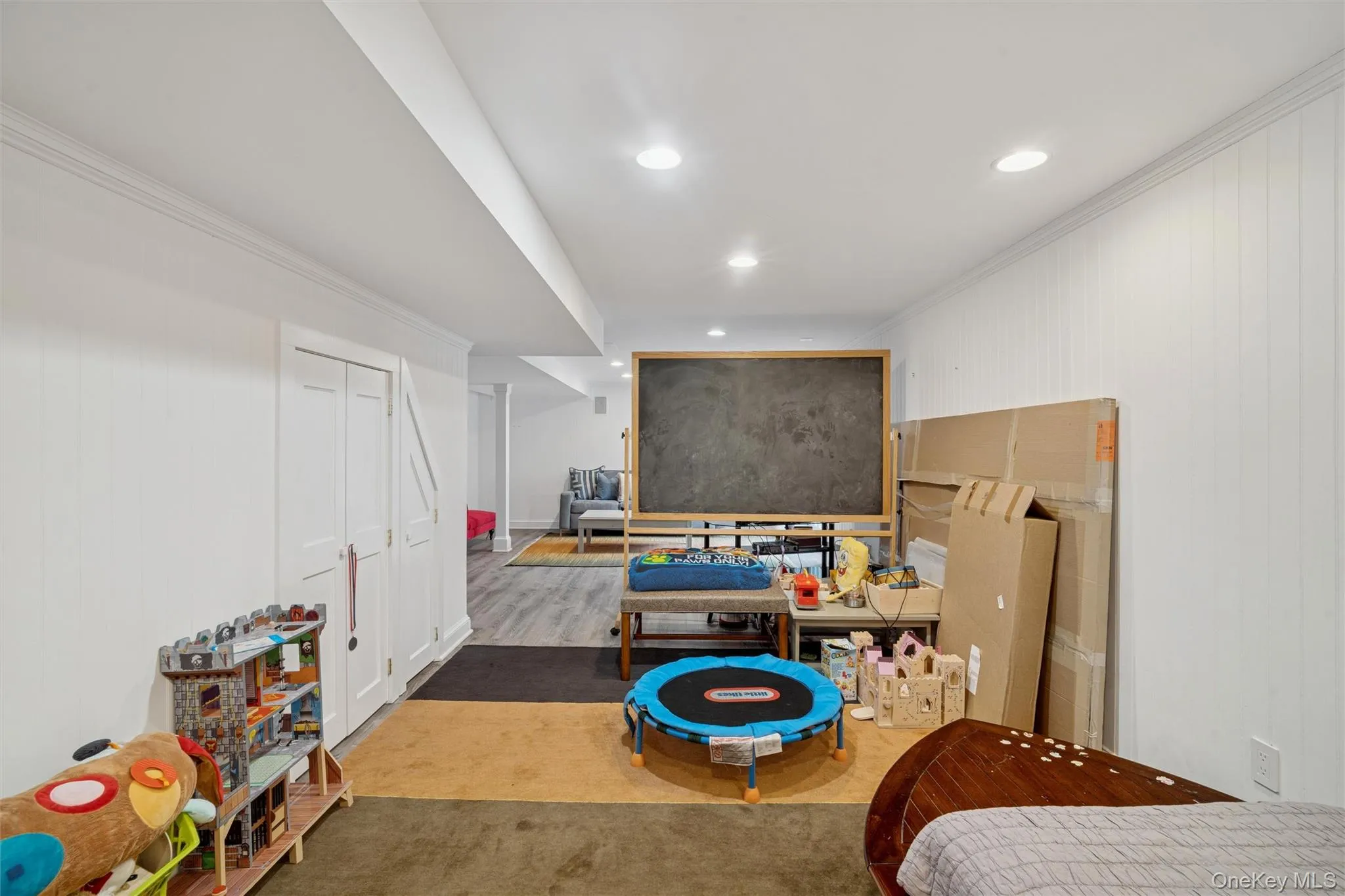 Bedroom with ornamental molding, recessed lighting, and wood finished floors Bedroom with ornamental molding, recessed lighting, and wood finished floors