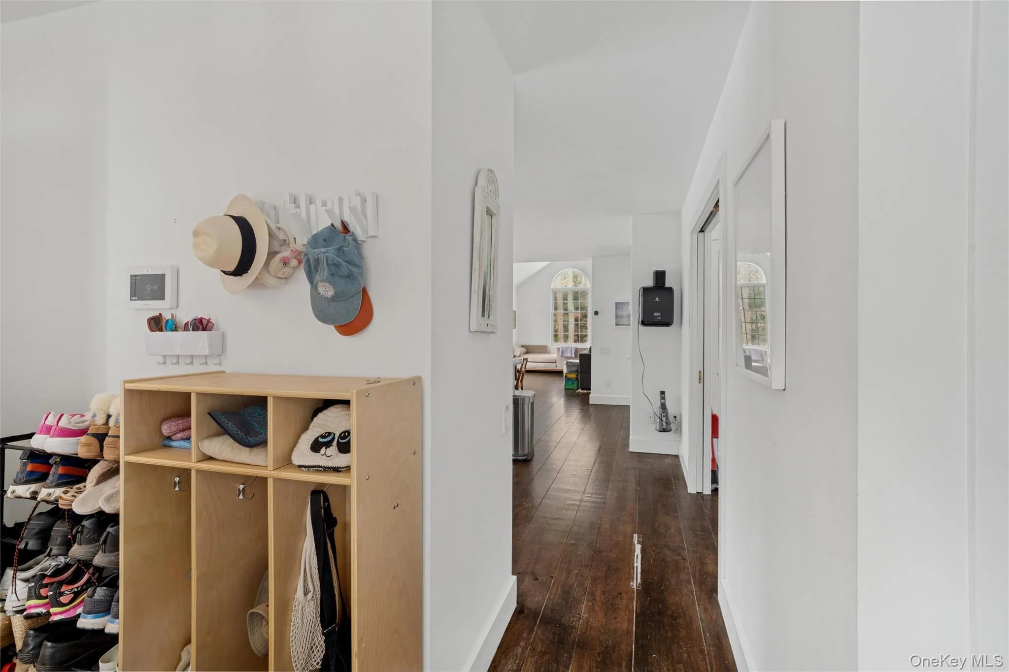 Corridor with dark wood-style flooring and baseboards Corridor with dark wood-style flooring and baseboards