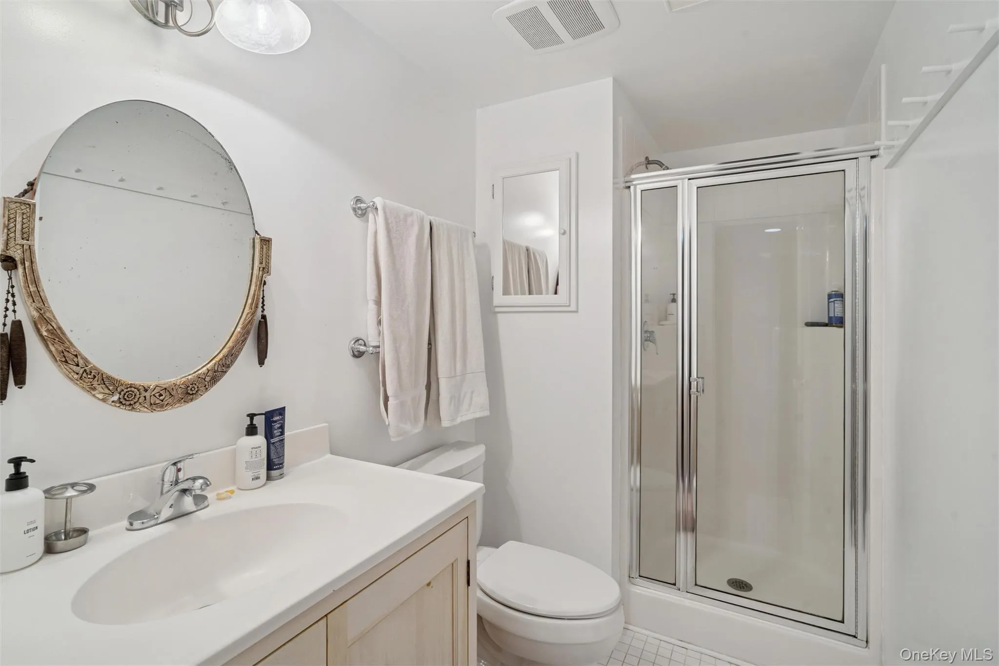 Bathroom with a stall shower and vanity Bathroom with a stall shower and vanity