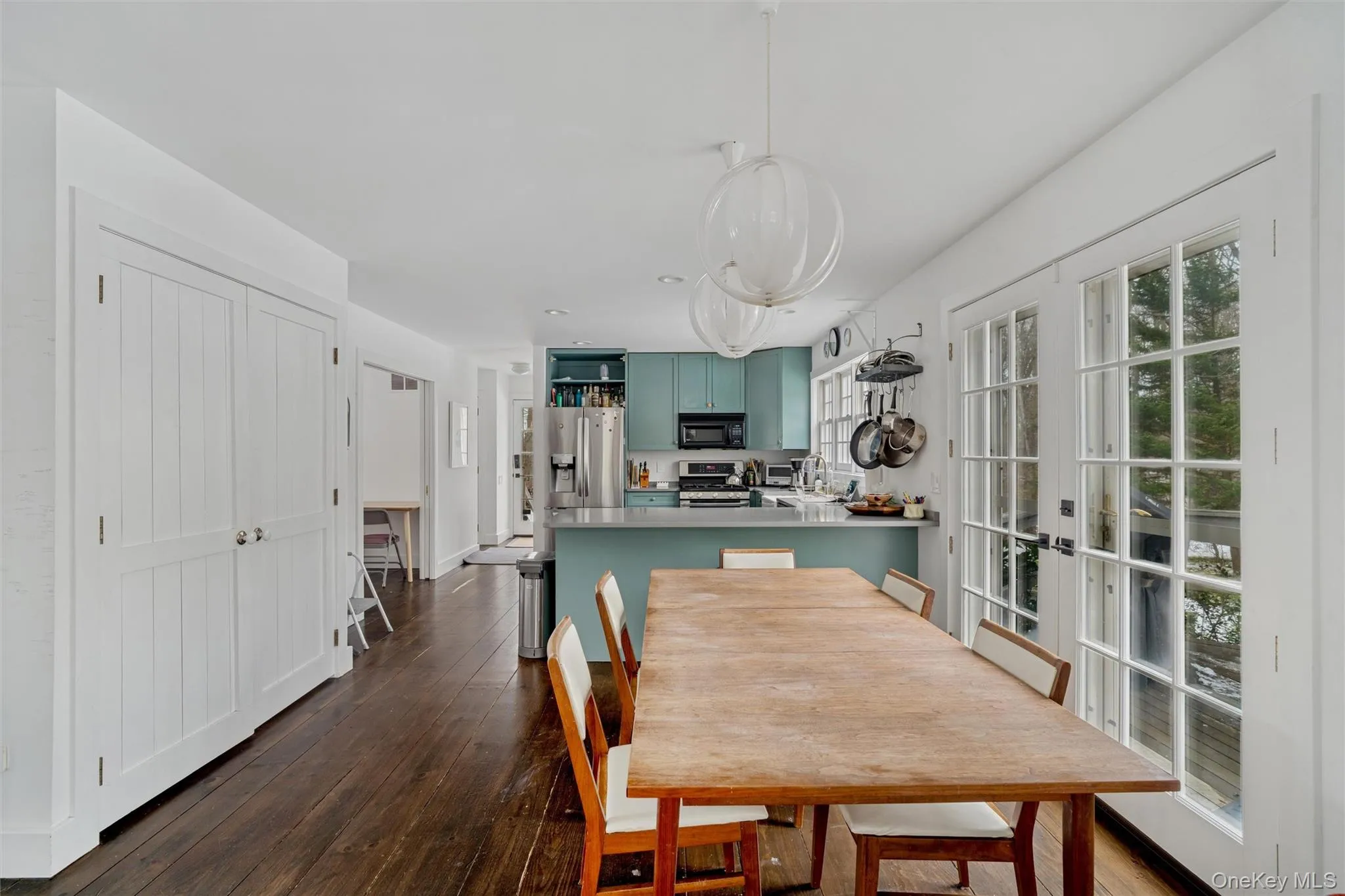 Dining space featuring french doors and dark wood-style floors Dining space featuring french doors and dark wood-style floors