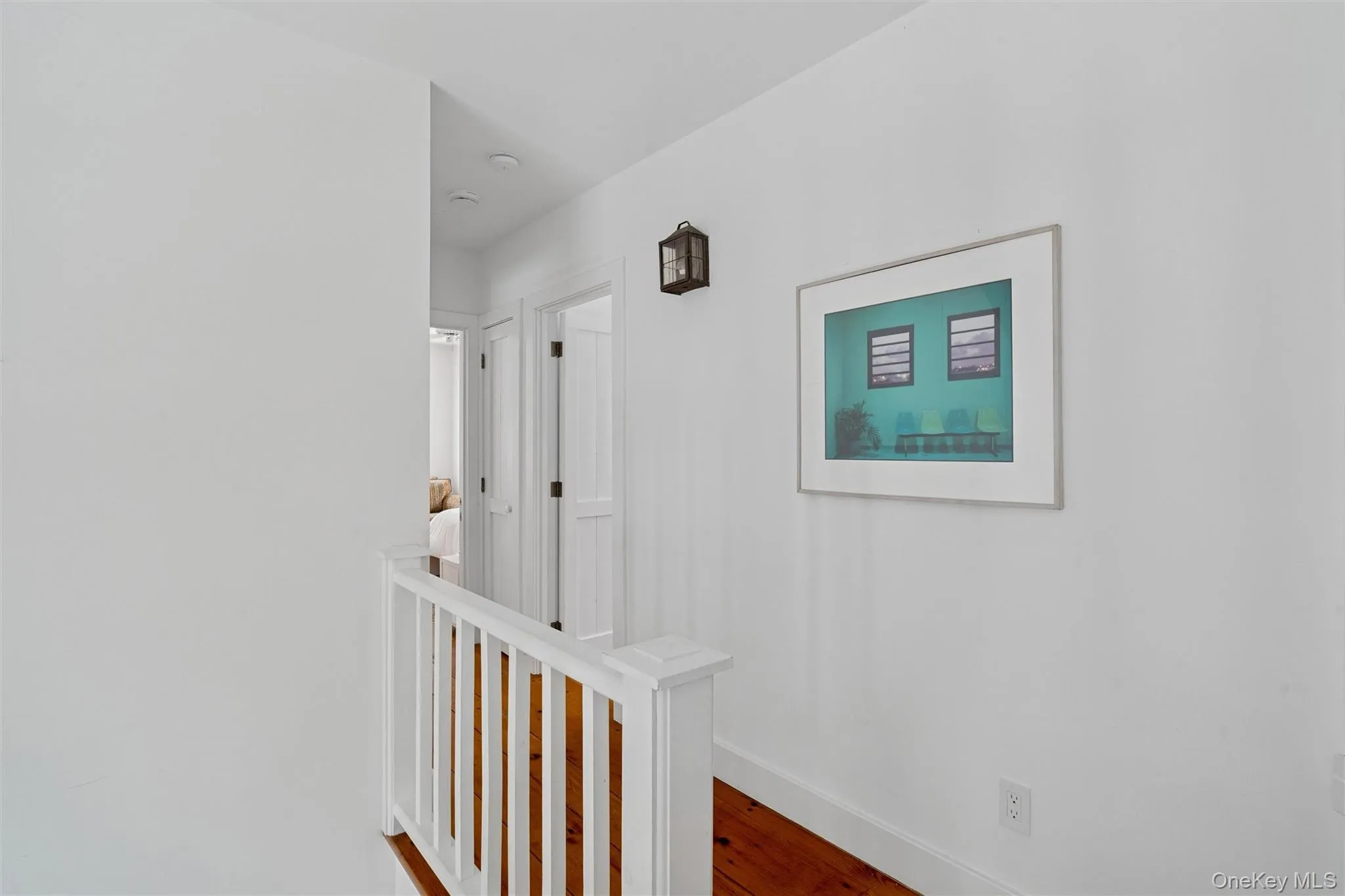 Corridor with wood finished floors and an upstairs landing Corridor with wood finished floors and an upstairs landing