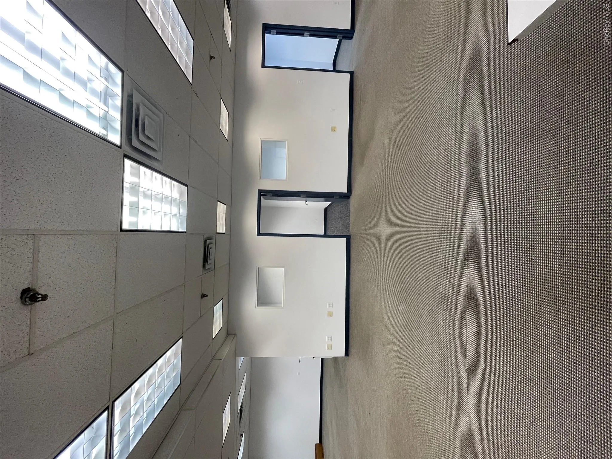 Unfurnished room with a drop ceiling and carpet floors Unfurnished room with a drop ceiling and carpet floors