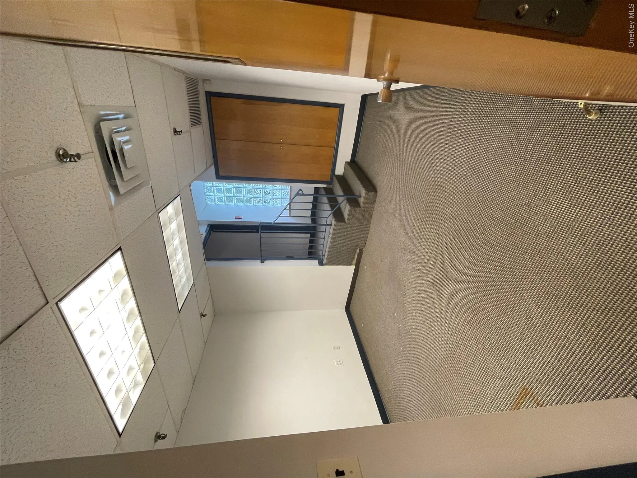Spare room featuring a paneled ceiling and carpet floors Spare room featuring a paneled ceiling and carpet floors