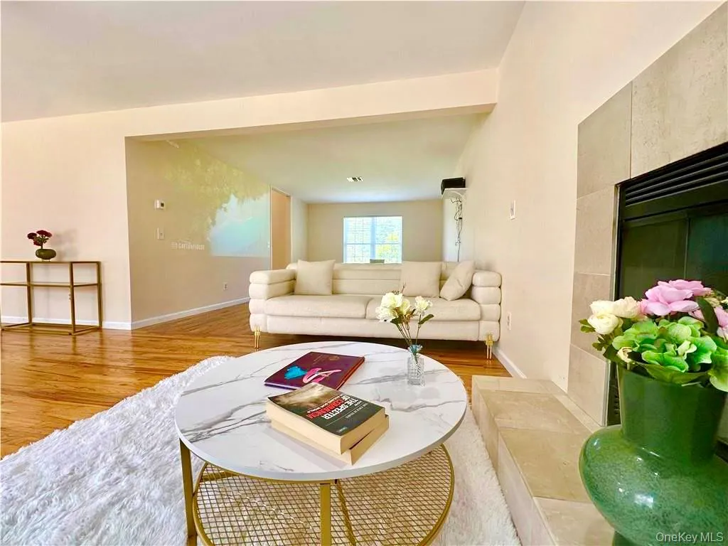 Living area featuring wood finished floors and baseboards Living area featuring wood finished floors and baseboards