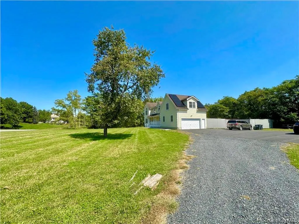 View of front of house featuring driveway, a front yard, and an attached garage View of front of house featuring driveway, a front yard, and an attached garage