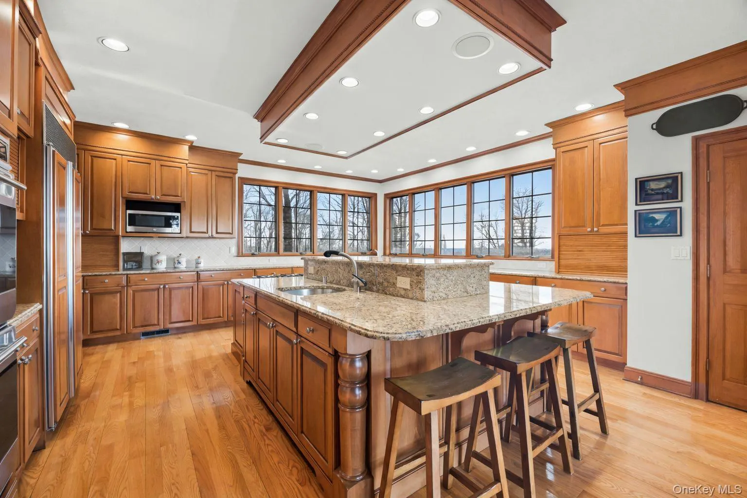 Chef's kitchen with high end appliances, granite countertops, and massive center island Chef's kitchen with high end appliances, granite countertops, and massive center island