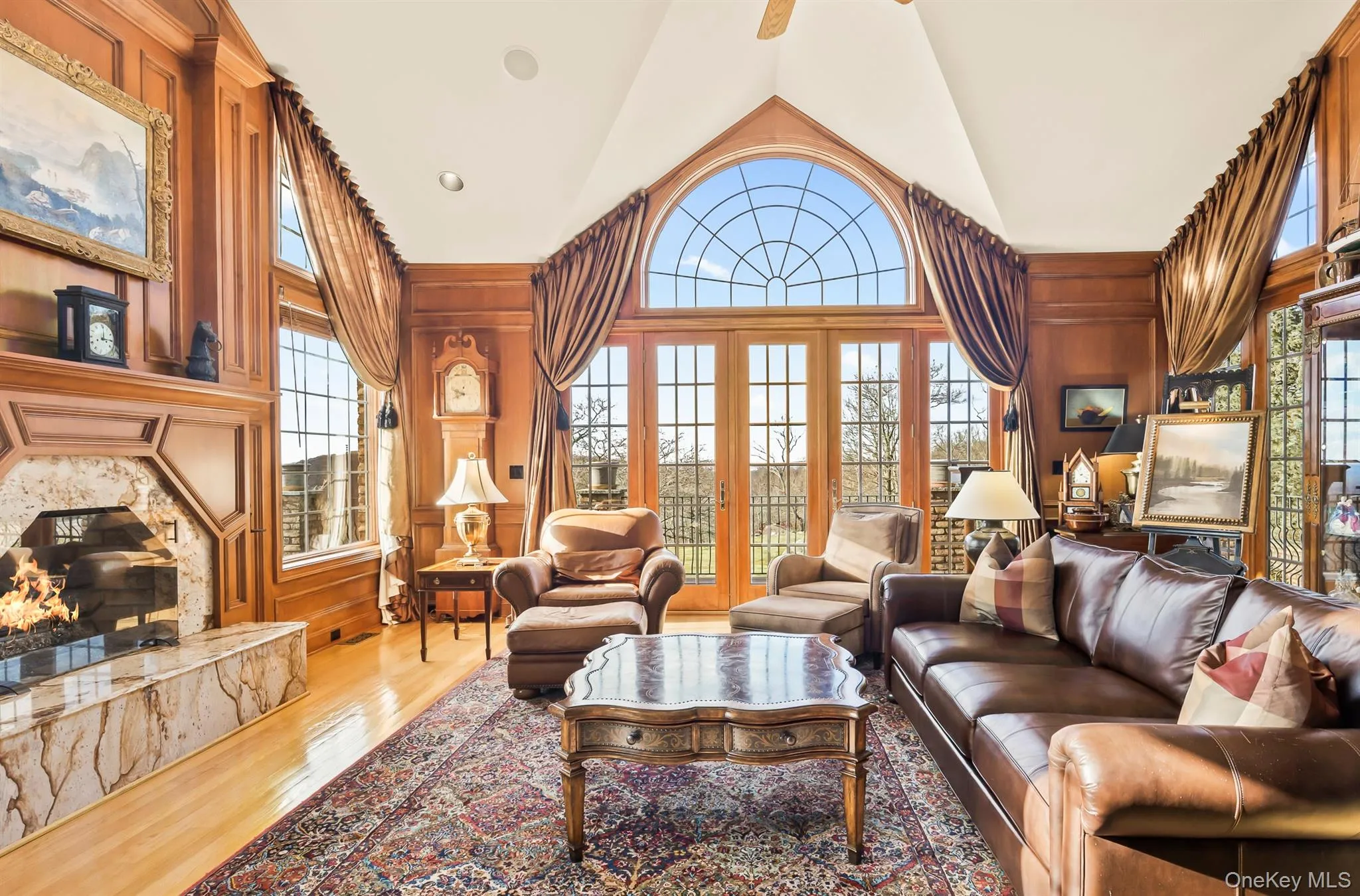 Cozy den with marble fireplace and french doors out to deck Cozy den with marble fireplace and french doors out to deck