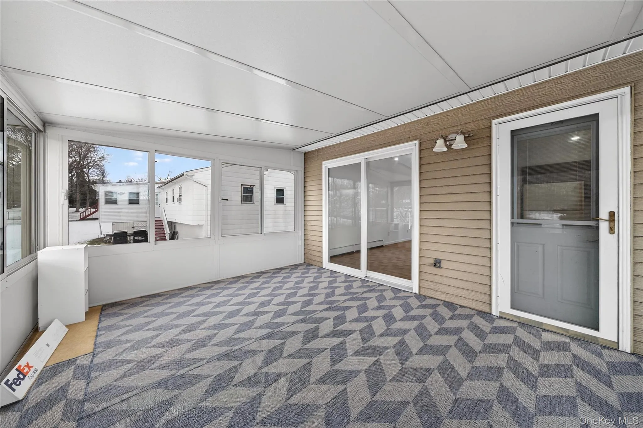 Unfurnished sunroom featuring a baseboard radiator Unfurnished sunroom featuring a baseboard radiator