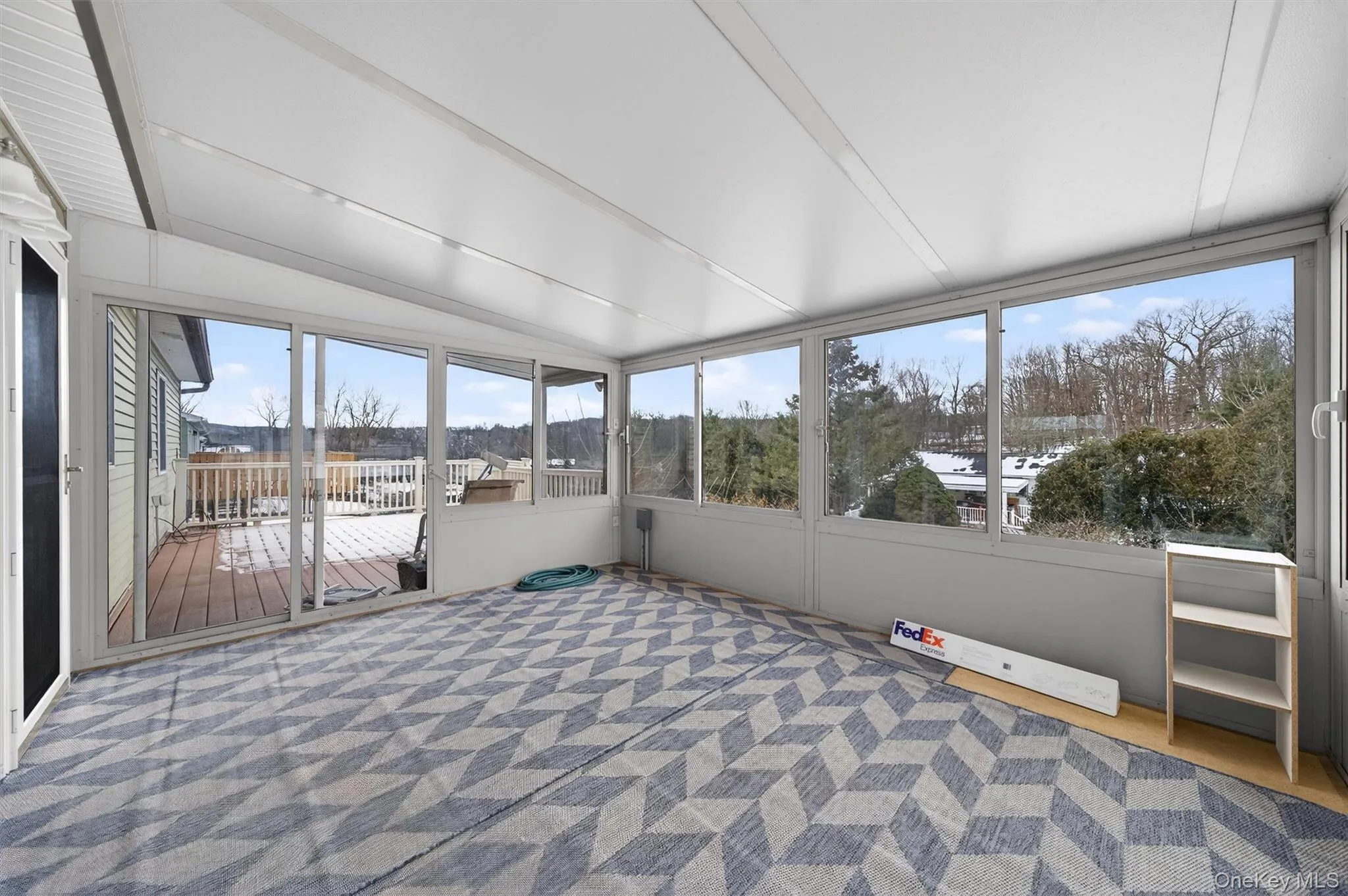 Unfurnished sunroom featuring lofted ceiling Unfurnished sunroom featuring lofted ceiling