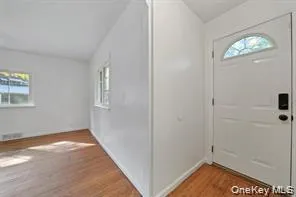 Entrance foyer featuring healthy amount of natural light, light wood-style flooring, and lofted ceiling Entrance foyer featuring healthy amount of natural light, light wood-style flooring, and lofted ceiling