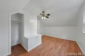 Bonus room featuring lofted ceiling, light wood-style flooring, and a ceiling fan Bonus room featuring lofted ceiling, light wood-style flooring, and a ceiling fan