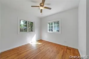 Spare room featuring wood finished floors and ceiling fan Spare room featuring wood finished floors and ceiling fan
