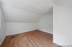 Bonus room featuring lofted ceiling and light wood-style floors Bonus room featuring lofted ceiling and light wood-style floors