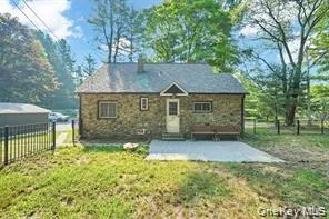 Rear view of property with a fenced backyard and a patio area Rear view of property with a fenced backyard and a patio area