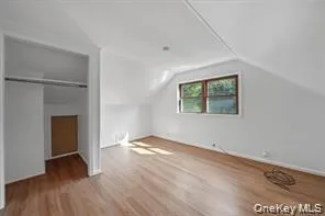 Additional living space with vaulted ceiling and wood finished floors Additional living space with vaulted ceiling and wood finished floors