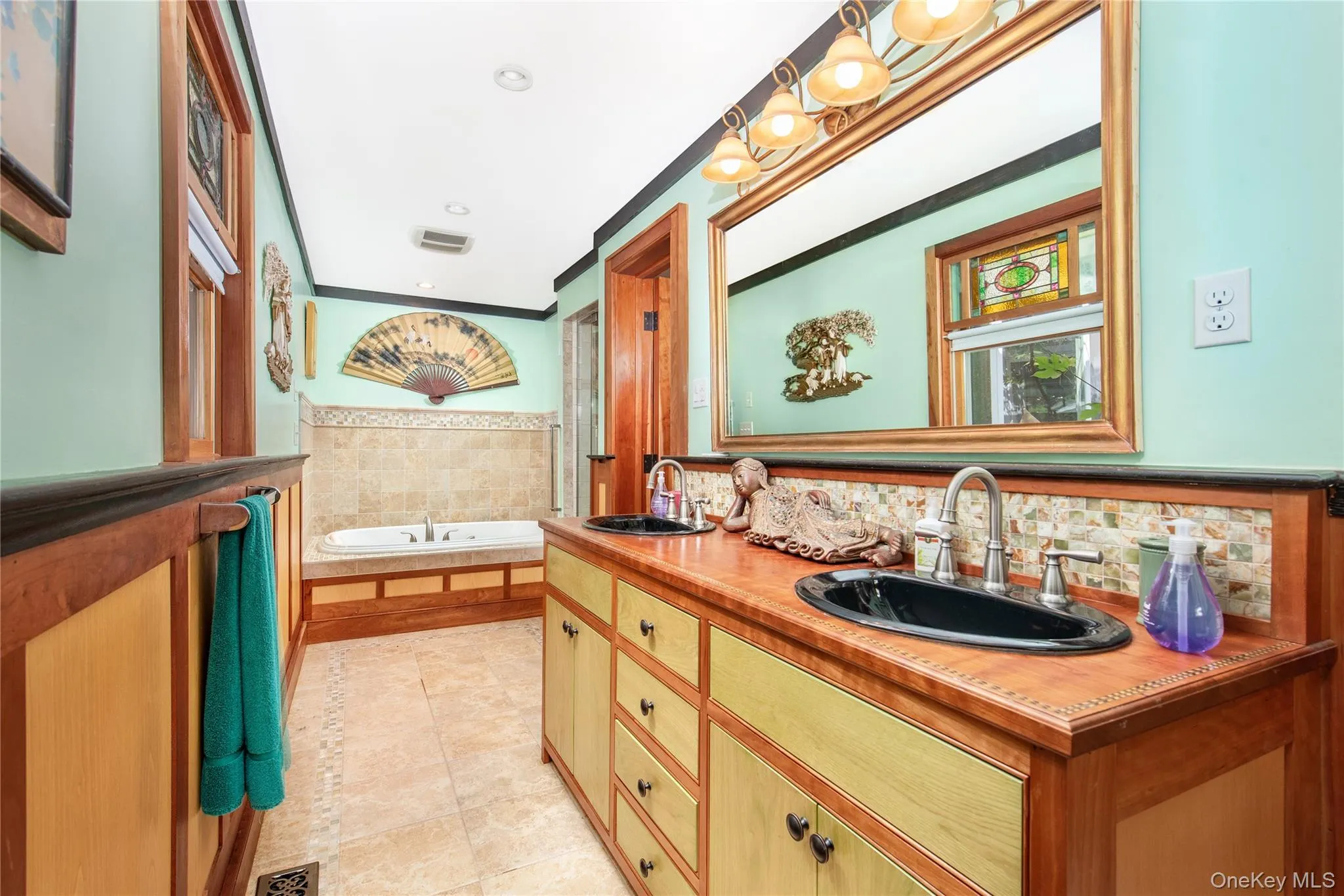 Full bathroom featuring double vanity, a bath, light tile patterned flooring, and recessed lighting Full bathroom featuring double vanity, a bath, light tile patterned flooring, and recessed lighting